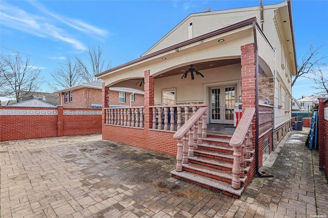 rear view of property featuring central AC unit, ceiling fan, a patio, and french doors