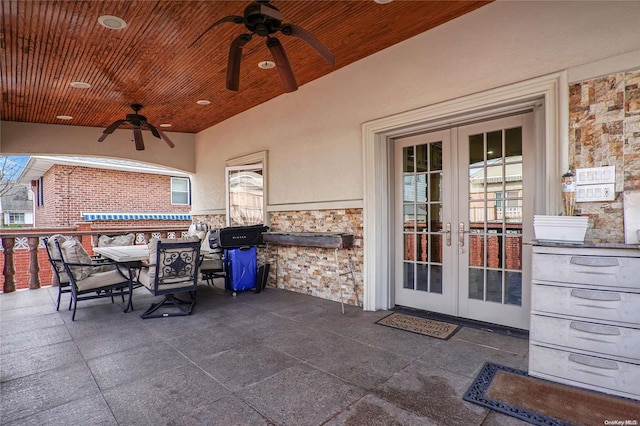 view of patio / terrace featuring area for grilling, ceiling fan, and french doors