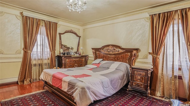 bedroom with wood-type flooring, multiple windows, and crown molding