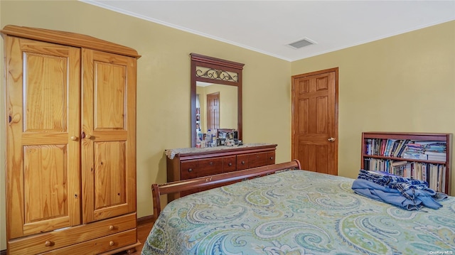 bedroom featuring hardwood / wood-style floors and ornamental molding