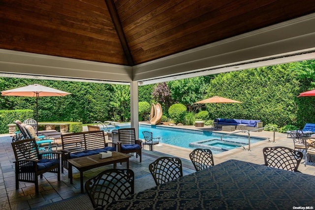 view of pool with a gazebo, an in ground hot tub, outdoor lounge area, and a patio