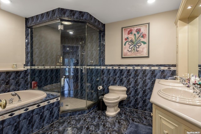 full bathroom with vanity, independent shower and bath, tile walls, and toilet