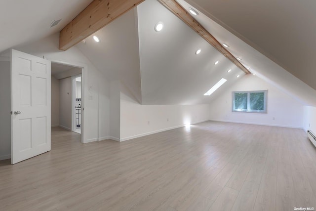 bonus room with light hardwood / wood-style floors and lofted ceiling with skylight