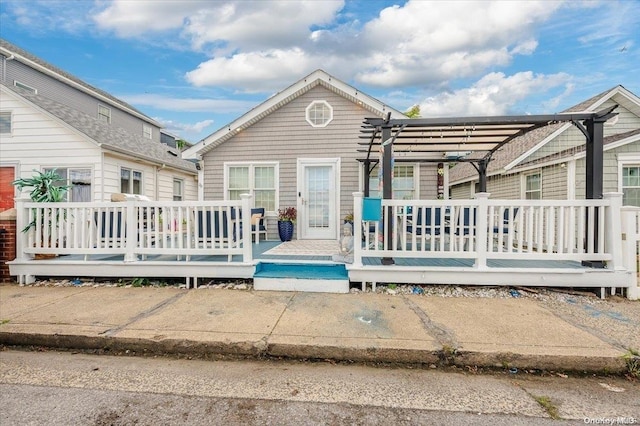 back of house featuring a pergola and a deck