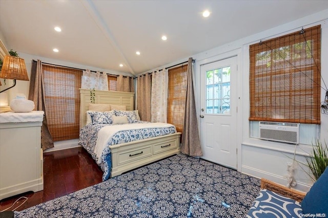 bedroom featuring dark hardwood / wood-style floors, cooling unit, and vaulted ceiling