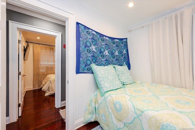 bedroom with dark hardwood / wood-style flooring and ornamental molding