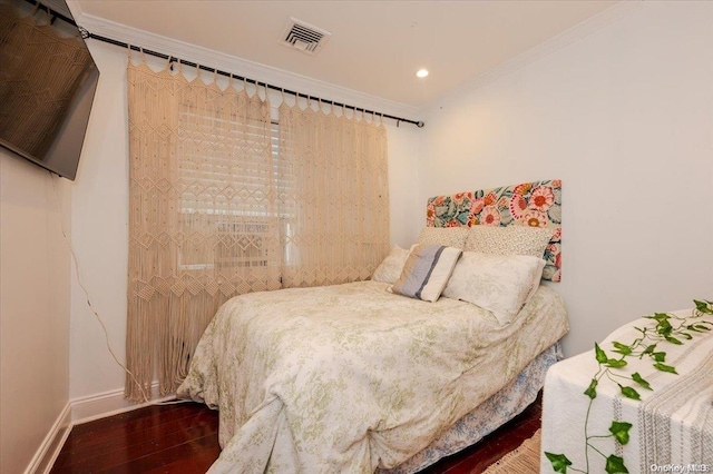 bedroom with wood-type flooring and ornamental molding