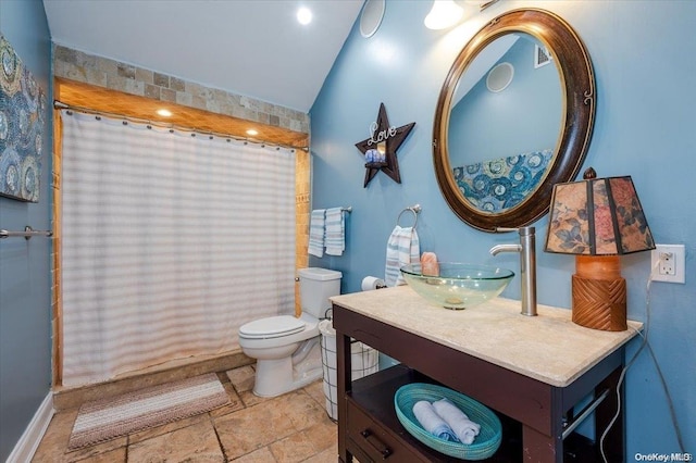 bathroom featuring curtained shower, vanity, vaulted ceiling, and toilet