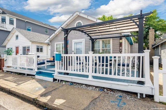 back of house with a deck and a pergola