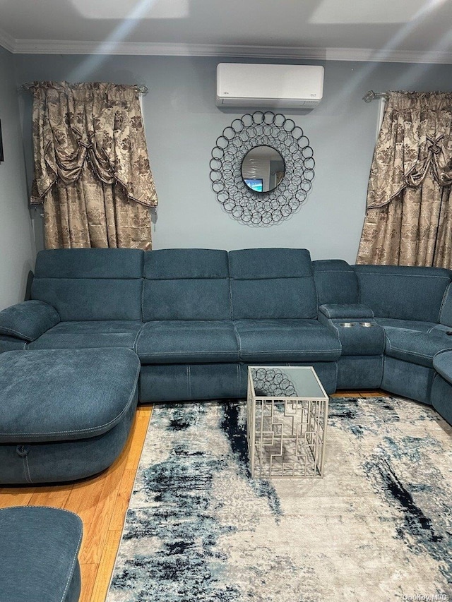 living room featuring a wall mounted air conditioner, hardwood / wood-style flooring, and ornamental molding