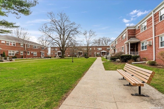 view of home's community with a lawn