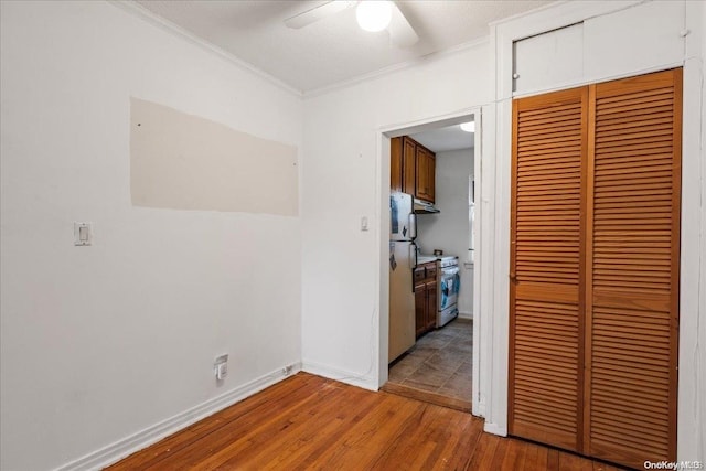 hallway featuring hardwood / wood-style floors and ornamental molding