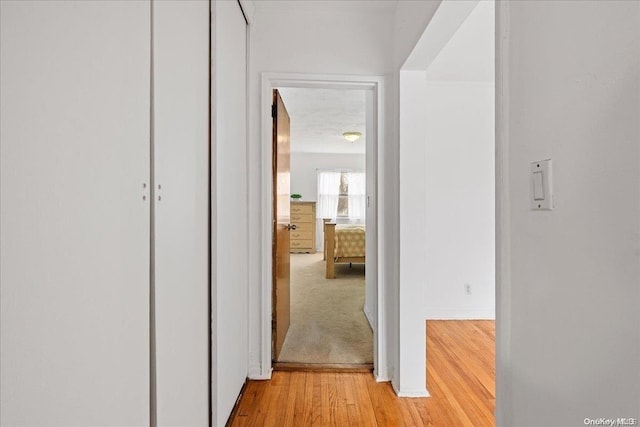 corridor with light hardwood / wood-style flooring