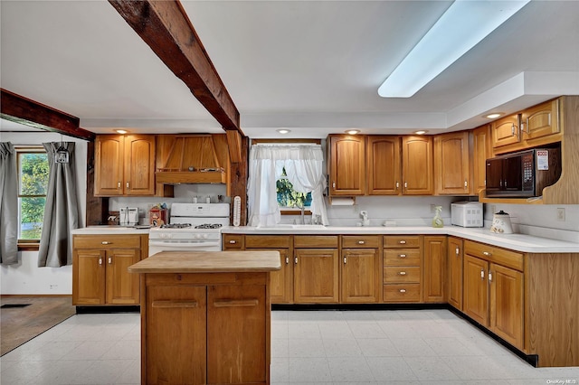 kitchen with beamed ceiling, a center island, white gas range oven, and premium range hood