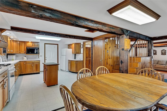 dining area with beamed ceiling