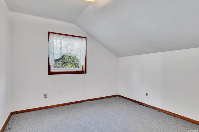 bonus room with carpet and vaulted ceiling