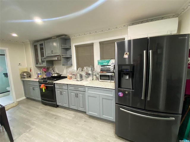 kitchen featuring gray cabinetry, light hardwood / wood-style floors, and stainless steel appliances