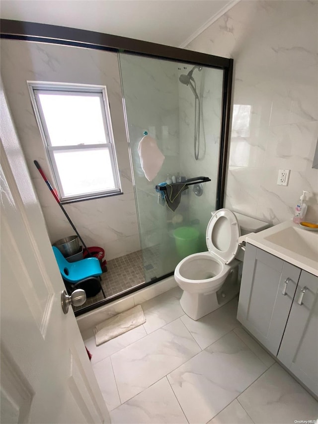 bathroom featuring vanity, crown molding, toilet, tile walls, and an enclosed shower