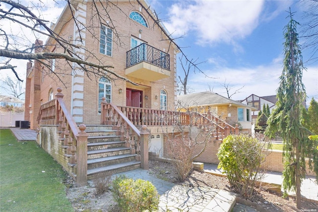 view of front of property with a balcony and cooling unit