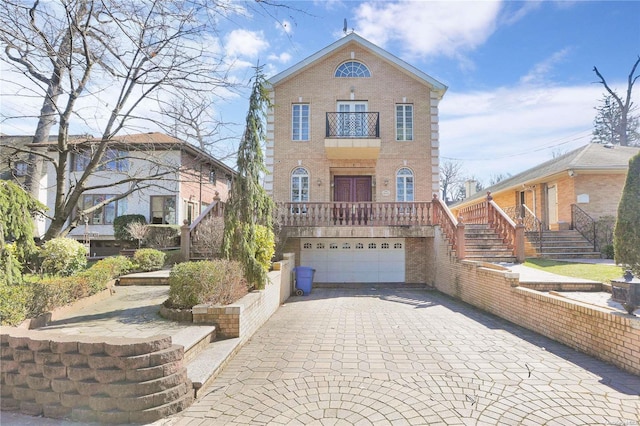 front of property featuring a garage and a balcony