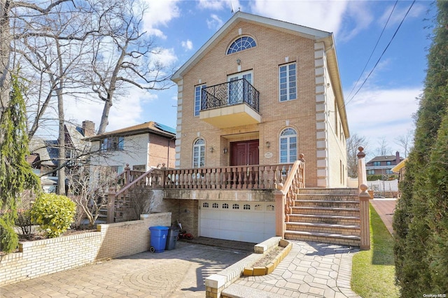 view of front of home featuring a garage and a balcony