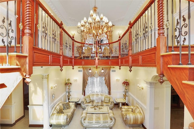 dining space featuring a towering ceiling, a notable chandelier, and ornamental molding