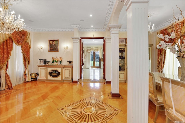 hall with a chandelier, decorative columns, parquet floors, and crown molding