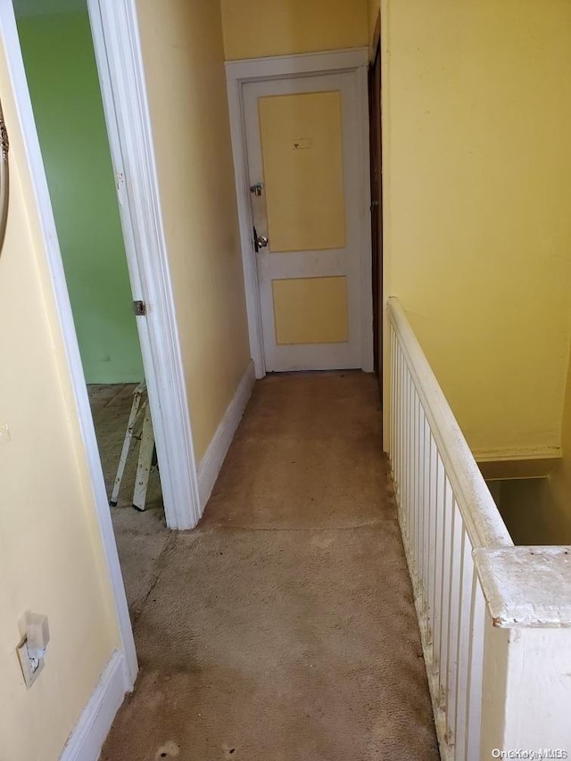 hallway with light colored carpet