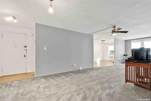 living room with light carpet and ceiling fan