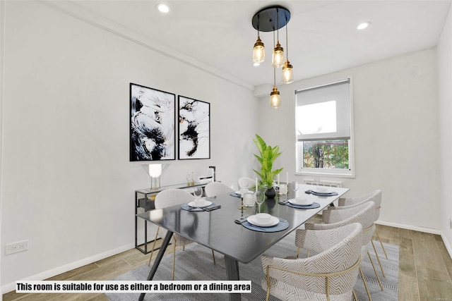 dining area featuring radiator heating unit and hardwood / wood-style floors