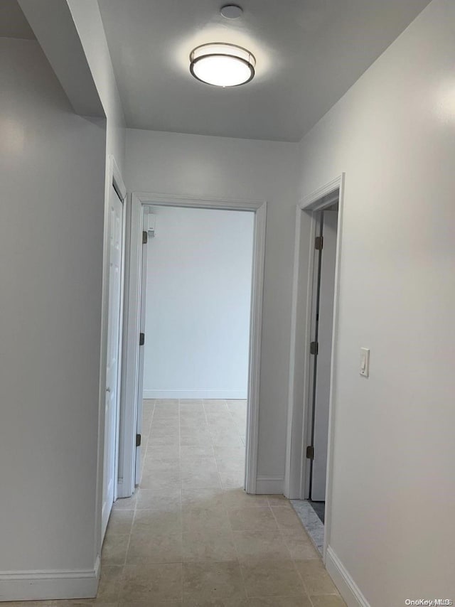 hallway featuring light tile patterned floors