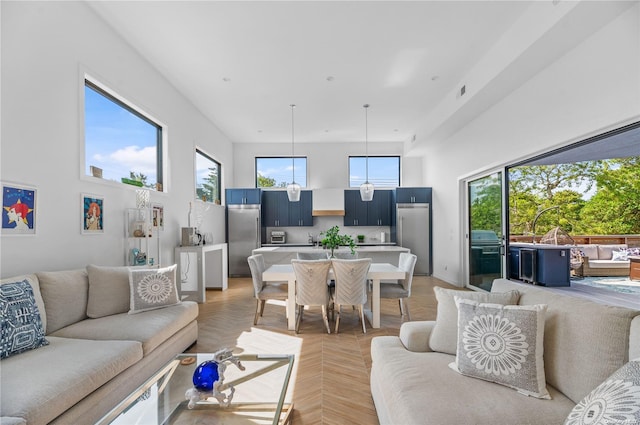 living room with light parquet flooring and a healthy amount of sunlight