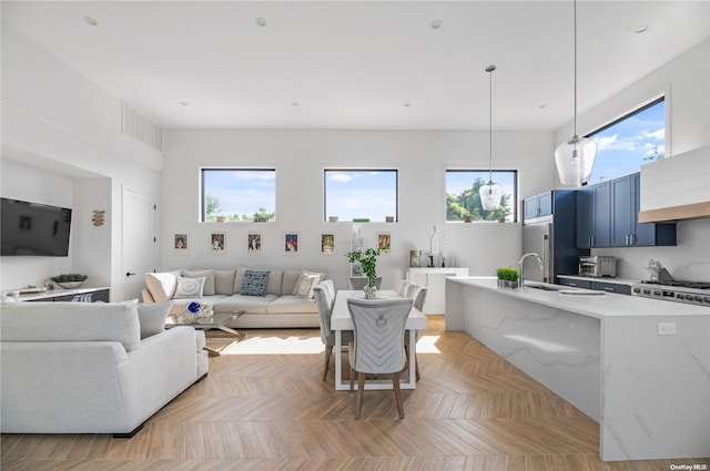 living room featuring a wealth of natural light and light parquet flooring