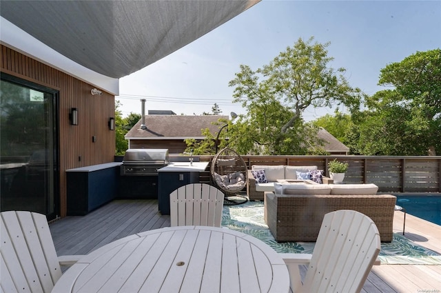 deck featuring an outdoor living space and a grill