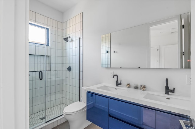 bathroom with vanity, toilet, and a shower with shower door