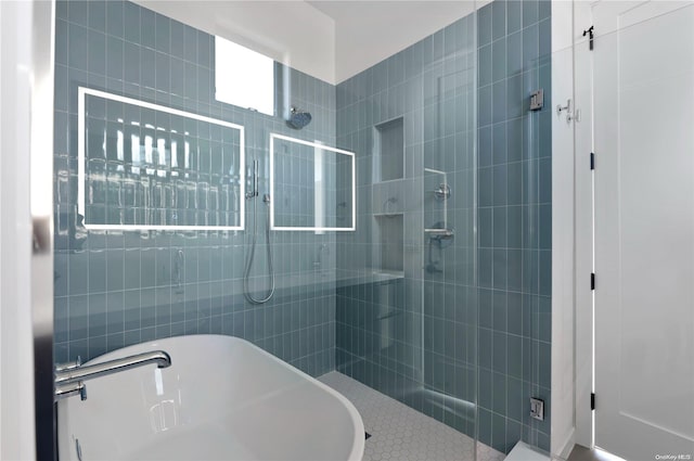 bathroom featuring separate shower and tub