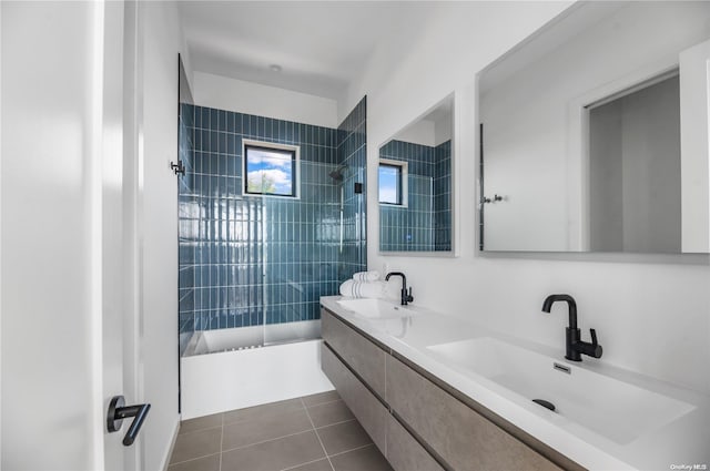 bathroom with tile patterned flooring, vanity, and tiled shower / bath