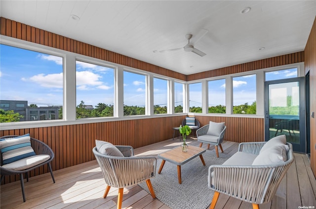 sunroom featuring ceiling fan and a wealth of natural light