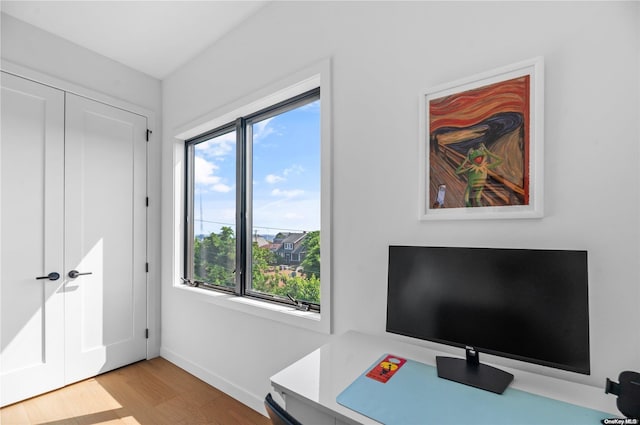 office with light hardwood / wood-style flooring