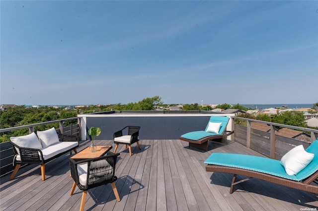 wooden terrace featuring an outdoor living space and a water view