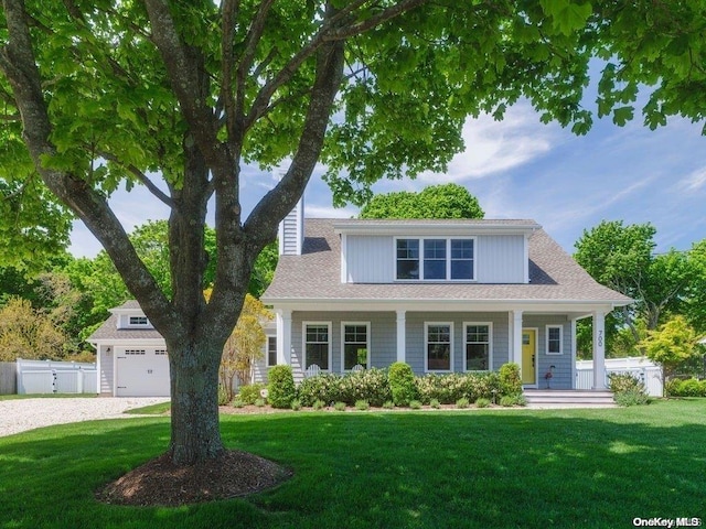 view of front of house featuring covered porch and a front lawn