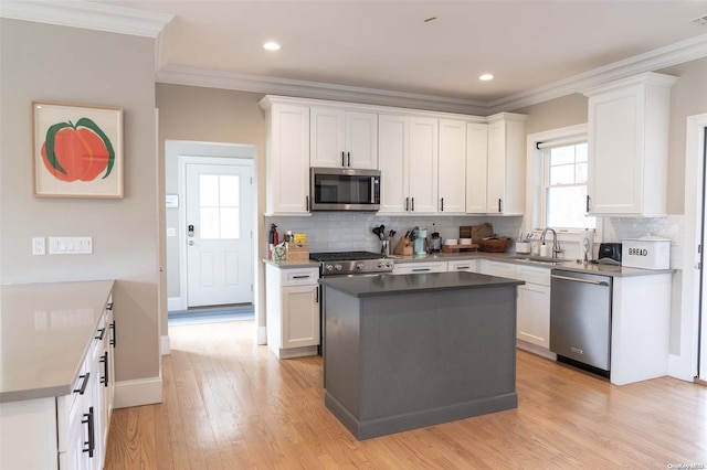 kitchen featuring stainless steel appliances, white cabinetry, and a kitchen island