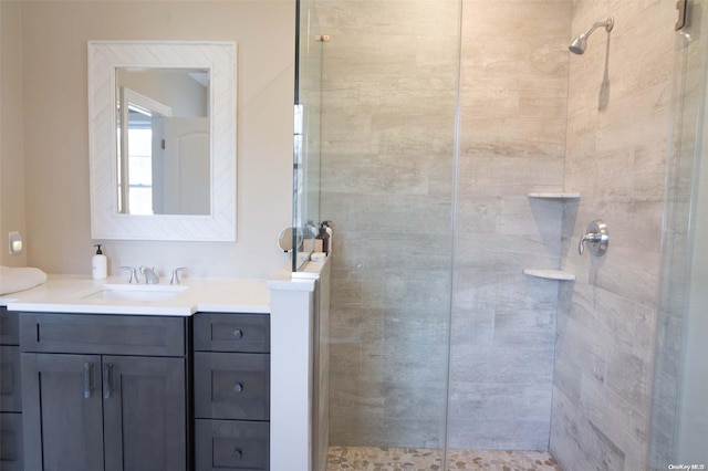 bathroom featuring vanity and tiled shower