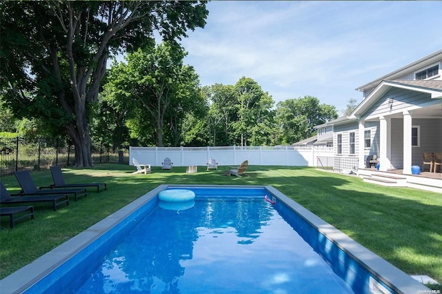 view of swimming pool featuring a lawn