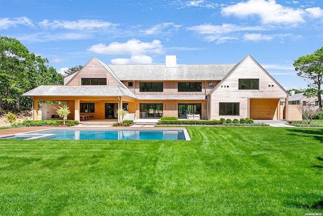 back of house with a yard and a patio