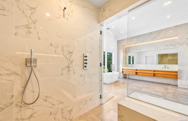 bathroom featuring vanity, shower with separate bathtub, and tile walls