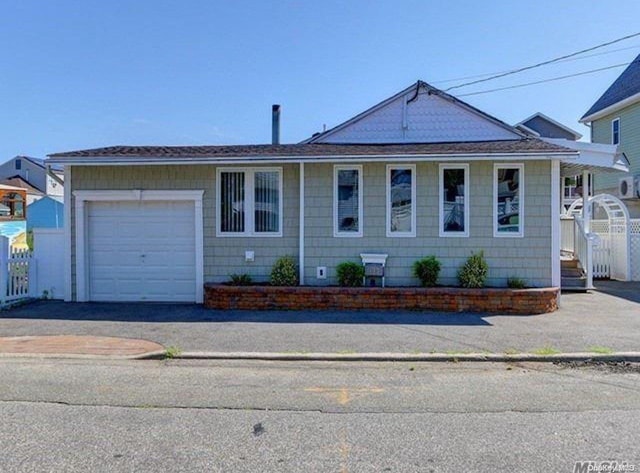 ranch-style house featuring a garage