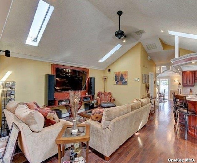 living room featuring a textured ceiling, ceiling fan, lofted ceiling, and hardwood / wood-style flooring