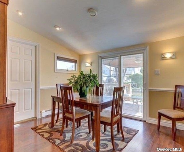 dining room with wood-type flooring and lofted ceiling