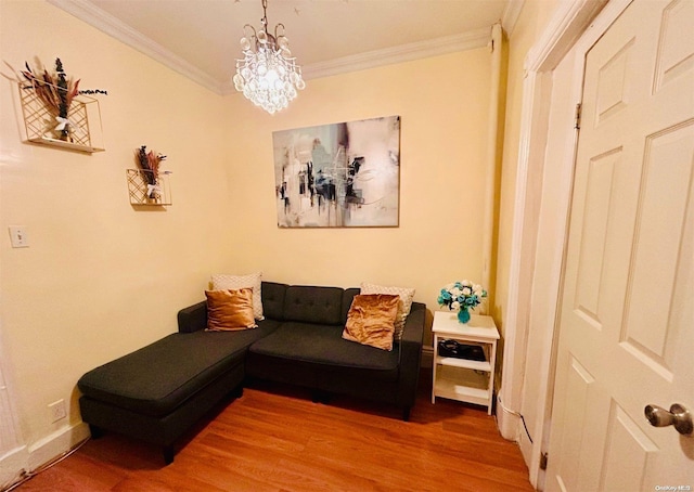 living room with hardwood / wood-style floors, an inviting chandelier, and ornamental molding